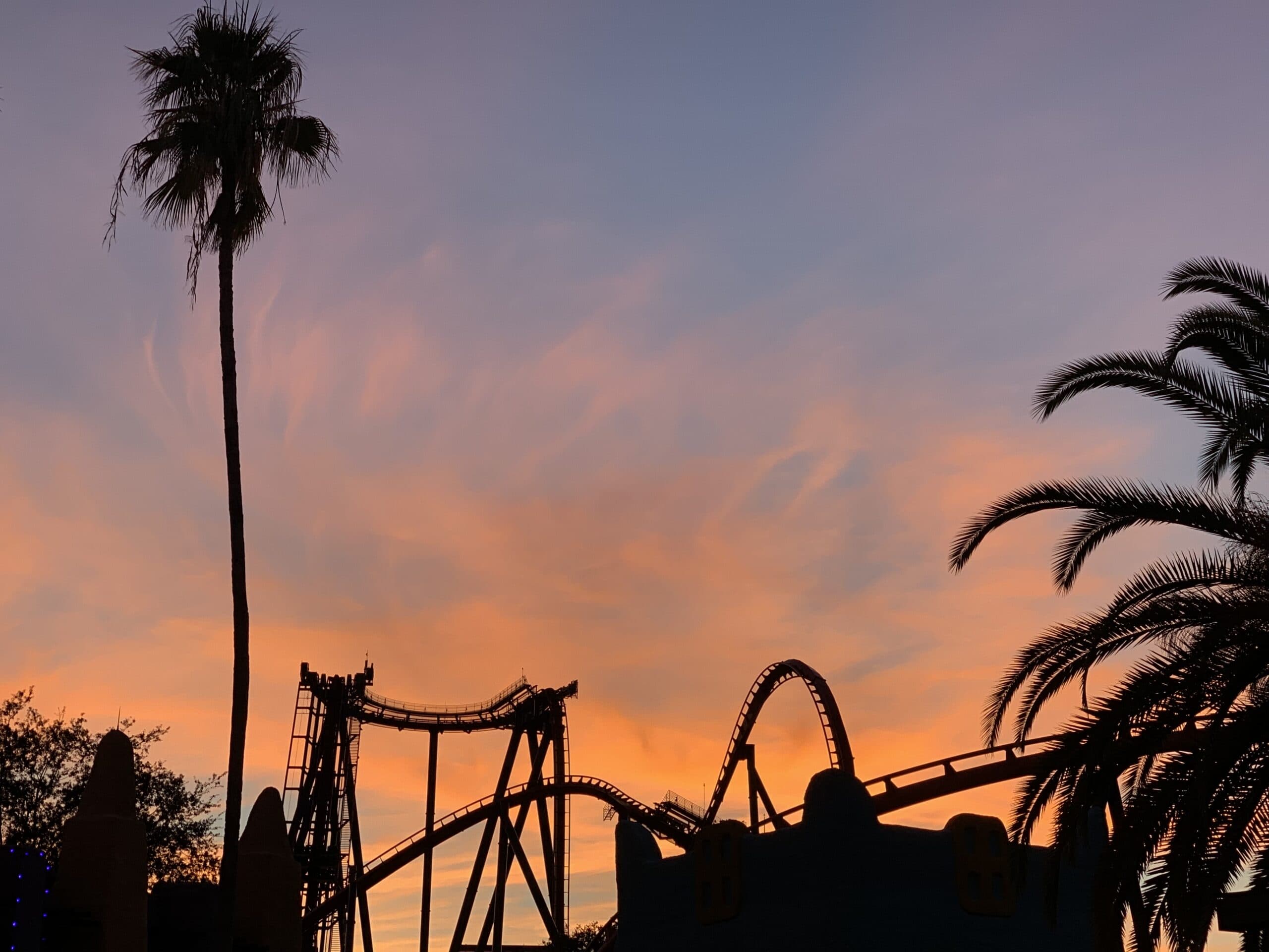 sunset over a theme park roller coaster
