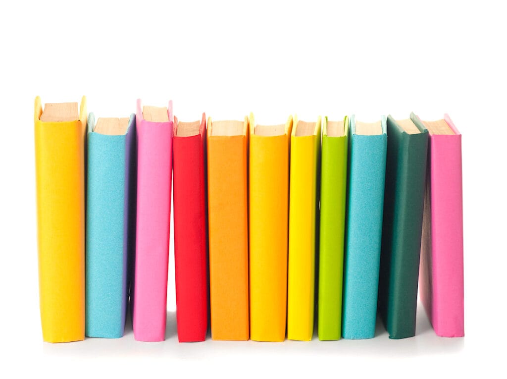 stack of colorful books on white background