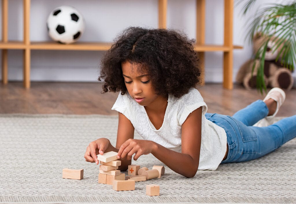 Girl Playing With Toys On Floor